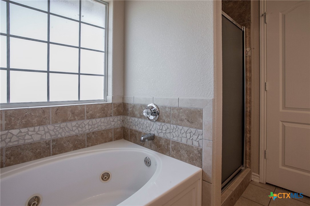 3710 Dewitt County Court Killeen, TX 76549 - Photo 9 of 18 a bathroom with a tub and shower
