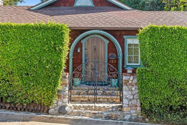 a front view of a house with garden