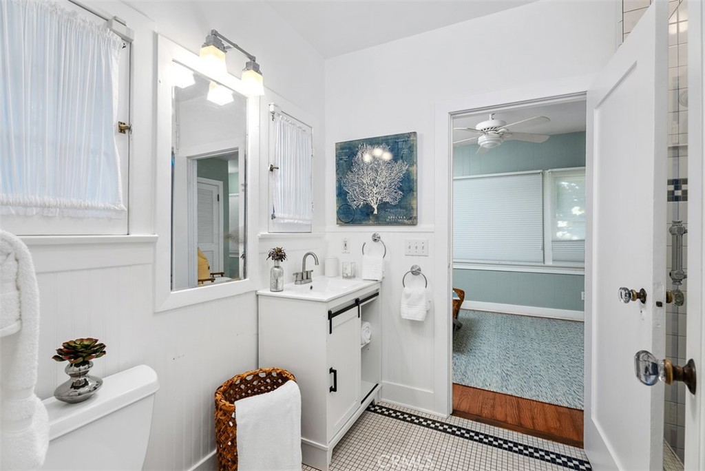 287 Myrtle Street Laguna Beach, CA 92651 - Photo 12 of 50 a bathroom with a sink and mirror with bathtub