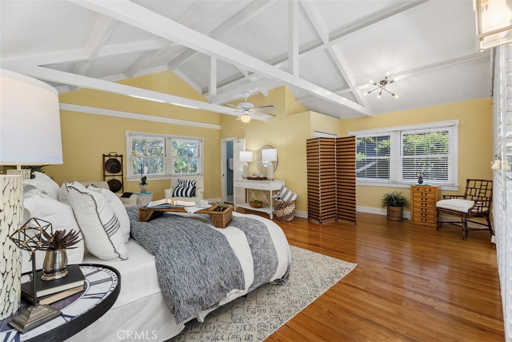 287 Myrtle Street Laguna Beach, CA 92651 - Photo 24 of 50 a spacious bedroom with a bed couch and a large window with wooden floor