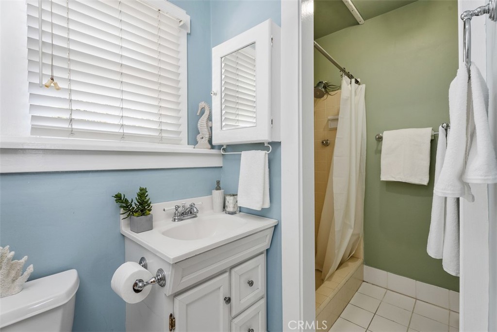 287 Myrtle Street Laguna Beach, CA 92651 - Photo 25 of 50 a kitchen with a sink and a refrigerator