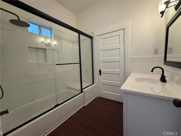 a bathroom with a shower and a sink