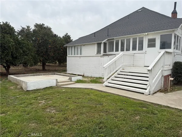 a view of a house with a yard and sitting area