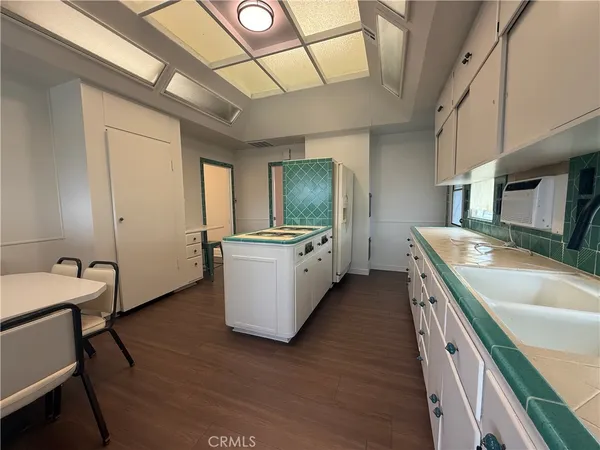 a spacious bathroom with a double vanity sink a mirror and bathtub