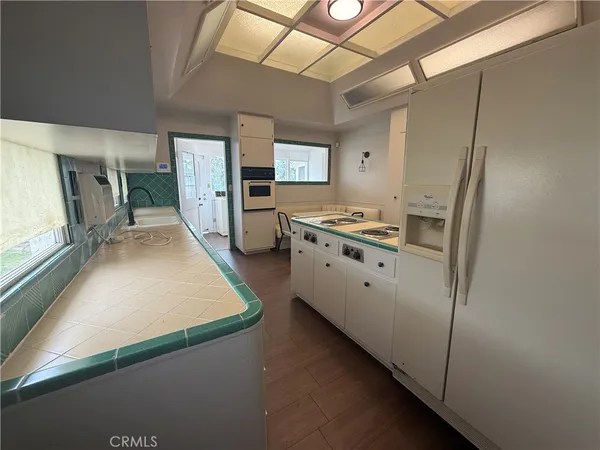 a kitchen with stainless steel appliances granite countertop a sink and wooden cabinets