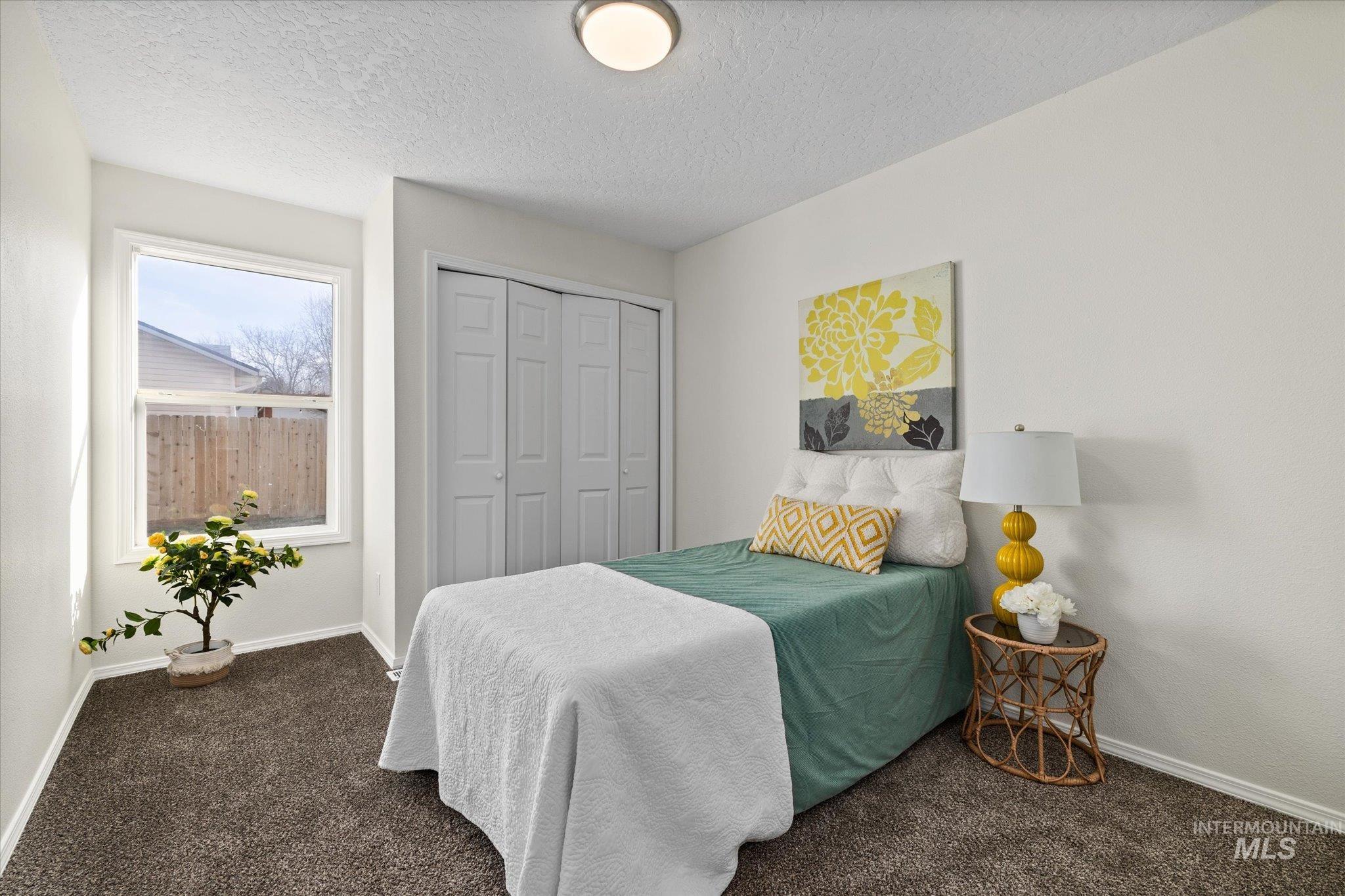 1399 West Gander Drive Meridian, ID 83642 - Photo 26 of 40 Bedroom featuring a textured ceiling, a closet, and carpet floors