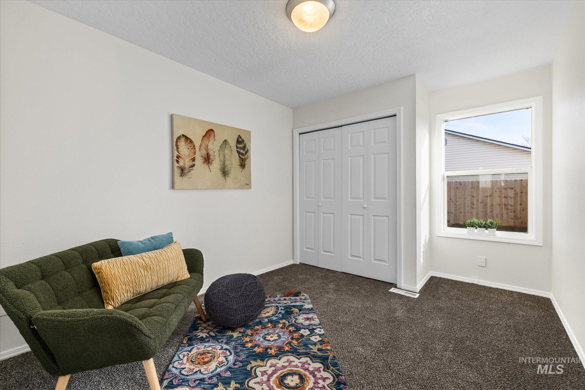 1399 West Gander Drive Meridian, ID 83642 - Photo 30 of 40 Living area with carpet flooring and a textured ceiling