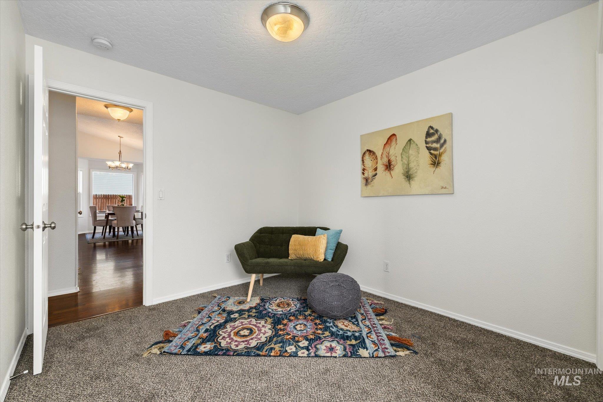 1399 West Gander Drive Meridian, ID 83642 - Photo 31 of 40 Sitting room featuring carpet, a textured ceiling, and a chandelier