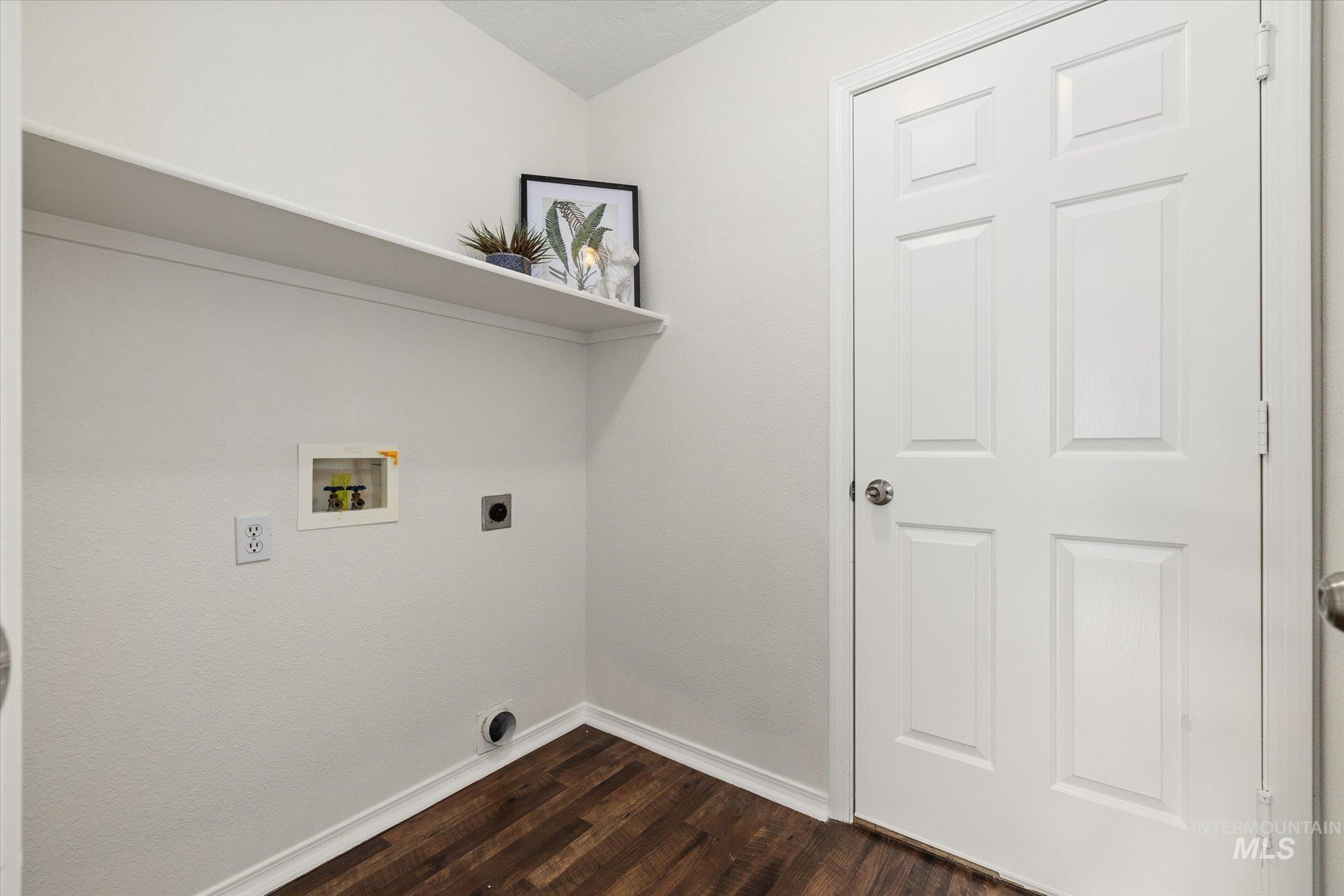 1399 West Gander Drive Meridian, ID 83642 - Photo 32 of 40 Washroom with electric dryer hookup, dark wood-type flooring, and washer hookup