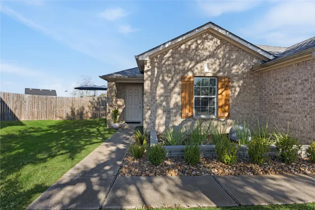 a front view of a house with garden