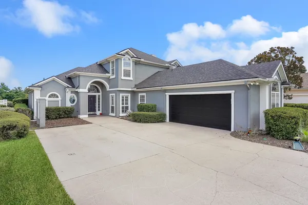 a front view of a house with a yard and garage