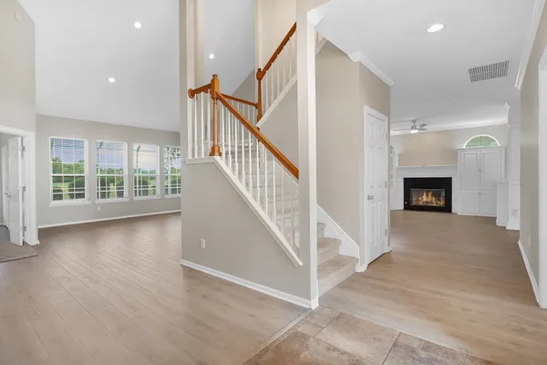 a view of entryway and hall with wooden floor