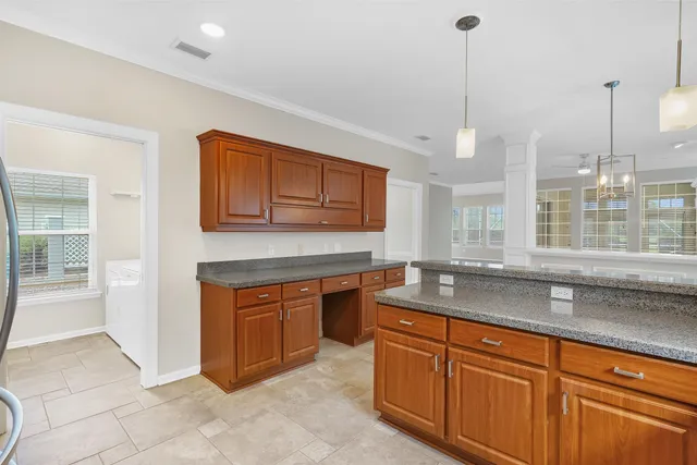 a kitchen with stainless steel appliances granite countertop a sink a stove and a granite counter tops