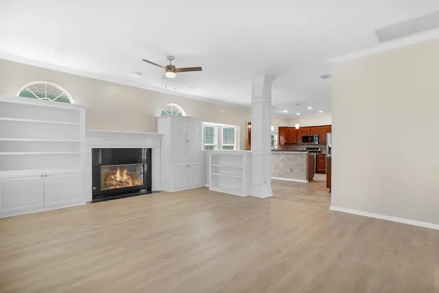 a view of a kitchen with a sink and a fireplace