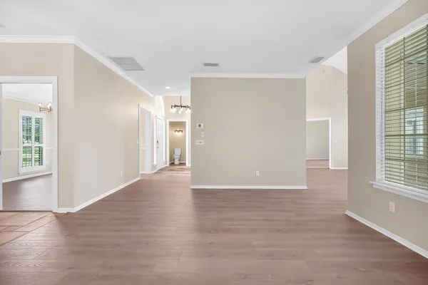 a view of a livingroom with wooden floor and windows