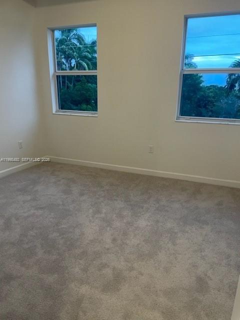 29009 Southwest 162nd Court, Unit 29009 Homestead, FL 33033 - Photo 13 of 26 a view of an empty room with a painting on the wall