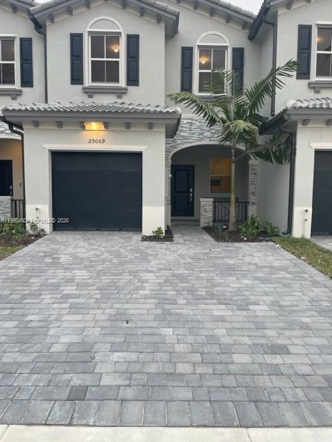 29009 Southwest 162nd Court, Unit 29009 Homestead, FL 33033 - Photo 2 of 26 a view of a brick house with many windows