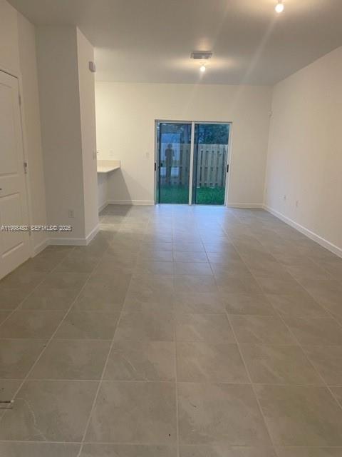 29009 Southwest 162nd Court, Unit 29009 Homestead, FL 33033 - Photo 3 of 26 a view of an empty room with a fireplace