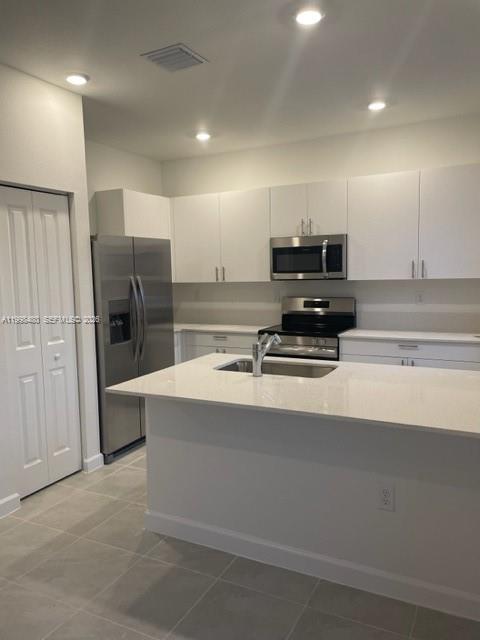 29009 Southwest 162nd Court, Unit 29009 Homestead, FL 33033 - Photo 6 of 26 a kitchen with stainless steel appliances a stove and refrigerator