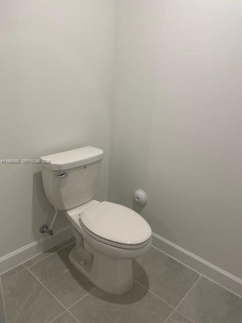 29009 Southwest 162nd Court, Unit 29009 Homestead, FL 33033 - Photo 9 of 26 a white toilet sitting next to a white wall