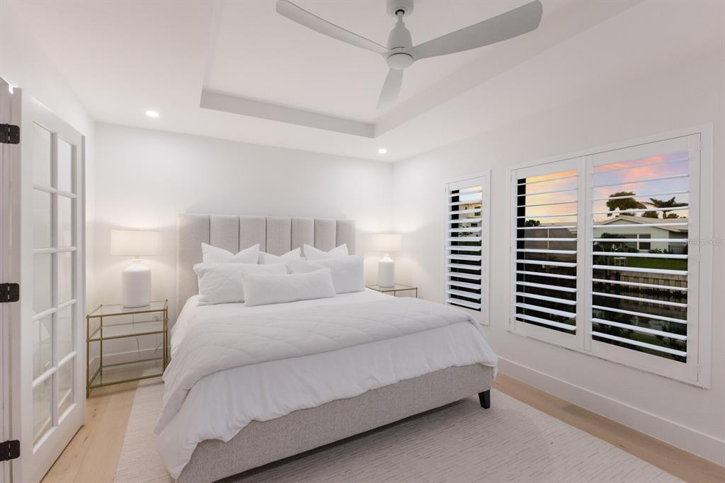 510 Putter Lane Longboat Key, FL 34228 - Photo 12 of 74 a bedroom with a bed and a walk in closet