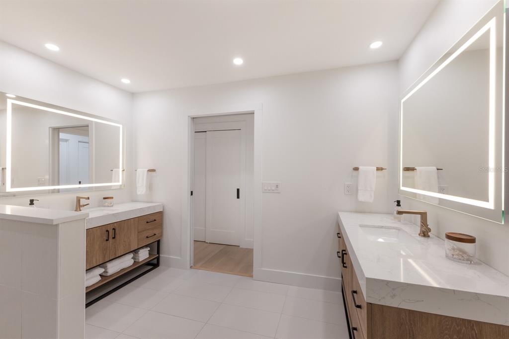 510 Putter Lane Longboat Key, FL 34228 - Photo 18 of 74 a bathroom with a double vanity sink and a mirror