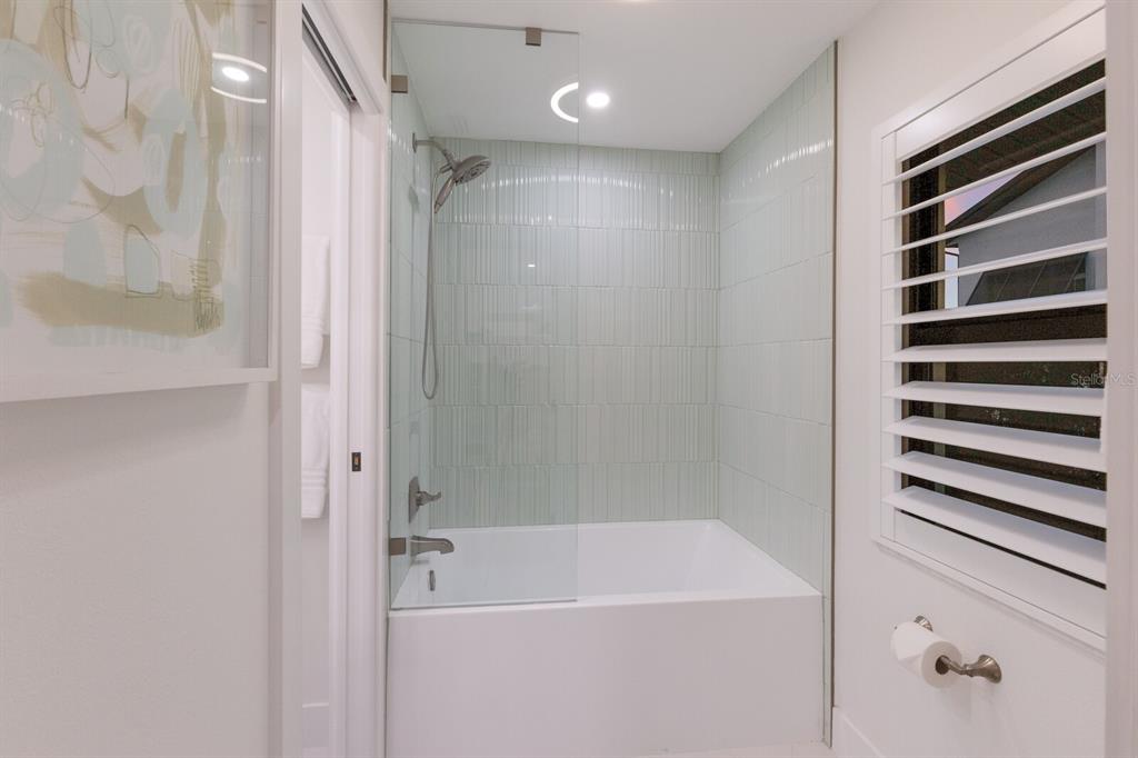 510 Putter Lane Longboat Key, FL 34228 - Photo 21 of 74 a bathroom with a bathtub and a shower
