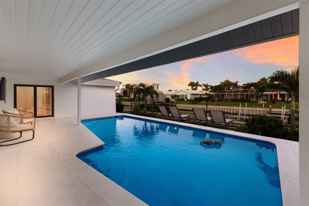 510 Putter Lane Longboat Key, FL 34228 - Photo 22 of 74 a view of swimming pool with outdoor seating and a floor to ceiling window