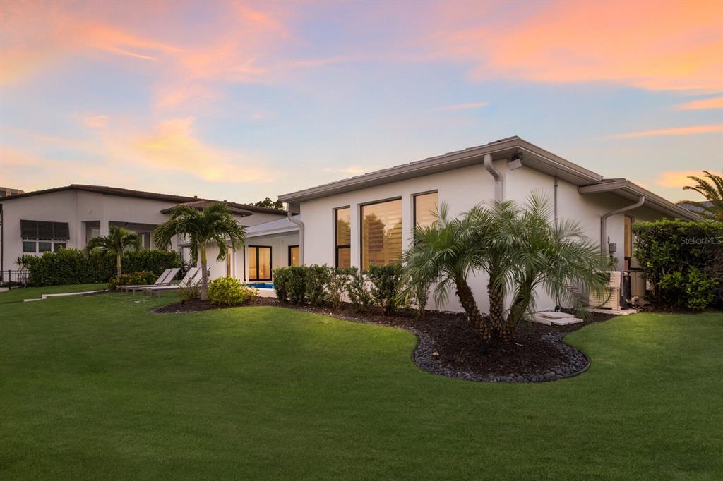 510 Putter Lane Longboat Key, FL 34228 - Photo 26 of 74 a front view of a house with a yard and porch