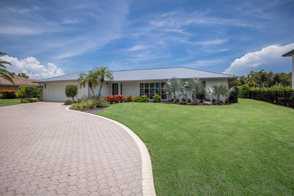 510 Putter Lane Longboat Key, FL 34228 - Photo 29 of 74 a front view of house with yard and green space
