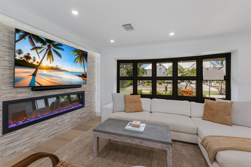 510 Putter Lane Longboat Key, FL 34228 - Photo 38 of 74 a living room with furniture and a flat screen tv