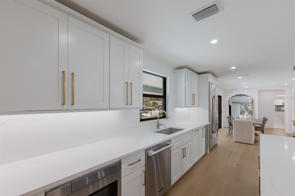 510 Putter Lane Longboat Key, FL 34228 - Photo 45 of 74 a large white kitchen with stainless steel appliances