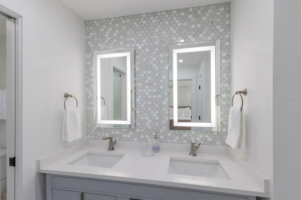 510 Putter Lane Longboat Key, FL 34228 - Photo 60 of 74 a bathroom with double vanity sinks and a mirror
