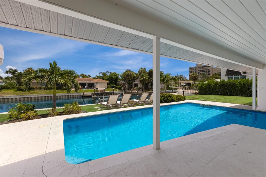 510 Putter Lane Longboat Key, FL 34228 - Photo 68 of 74 a view of a swimming pool with a patio and a garden