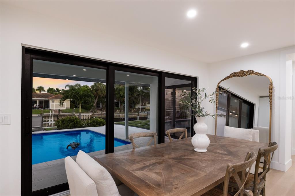 510 Putter Lane Longboat Key, FL 34228 - Photo 8 of 74 a view of a dining room with furniture window and wooden floor