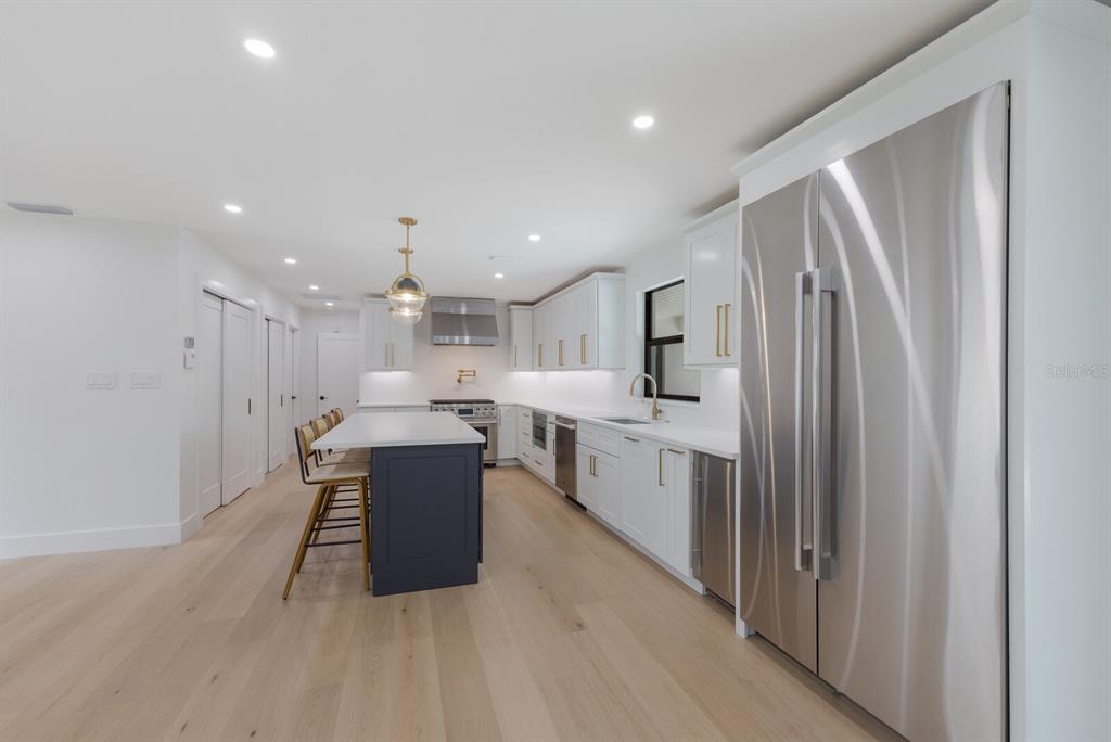 510 Putter Lane Longboat Key, FL 34228 - Photo 10 of 74 a large kitchen with a large counter top appliances and cabinets