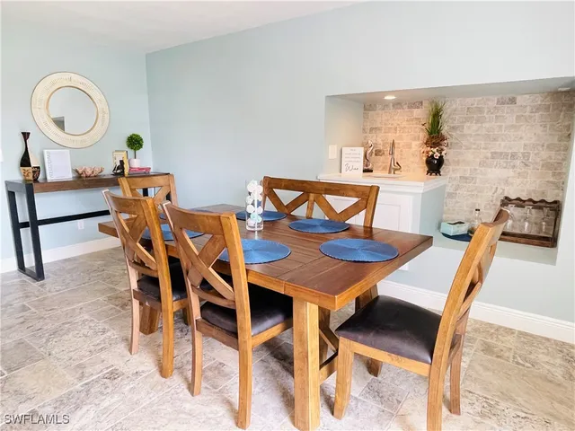 a dining room with furniture a mirror and wooden floor