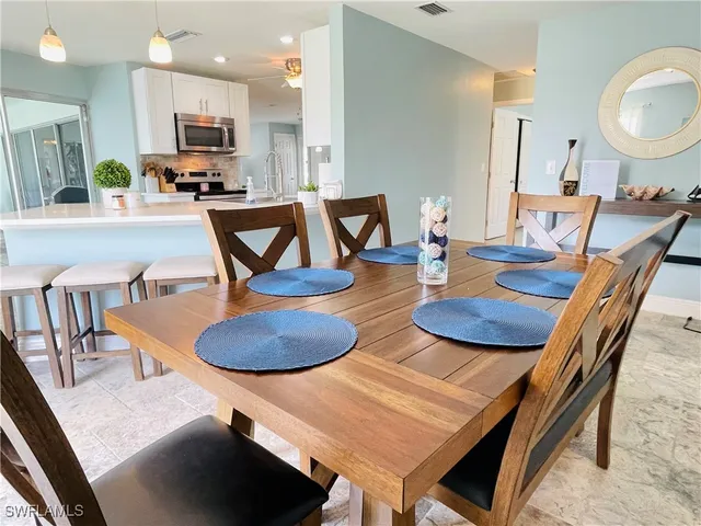 a view of a dining room with furniture and a window