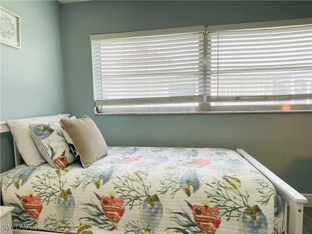 a bedroom with a bed and a desk