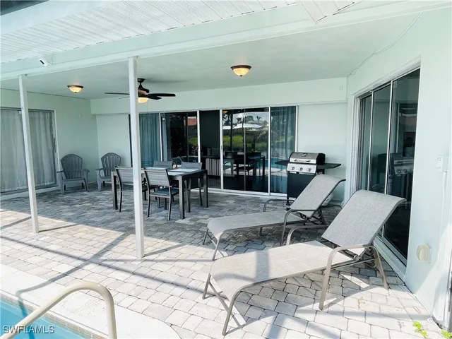 a kitchen with white cabinets and sink
