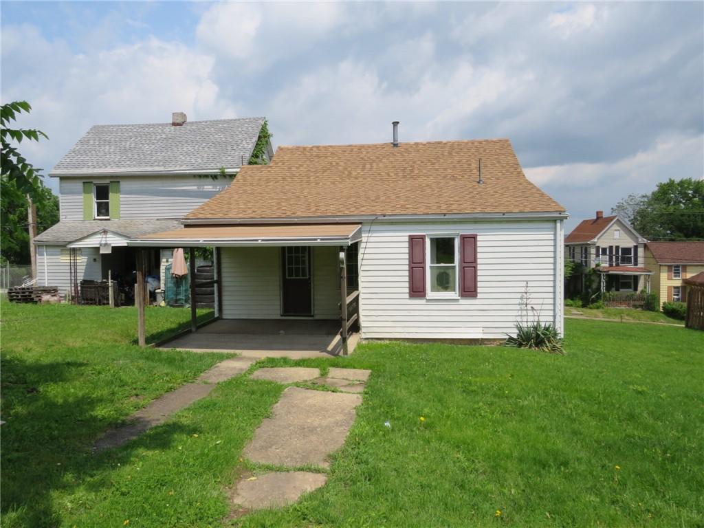 666 Ewing Street Washington, PA 15301 - Photo 15 of 22 a front view of a house with a garden and yard