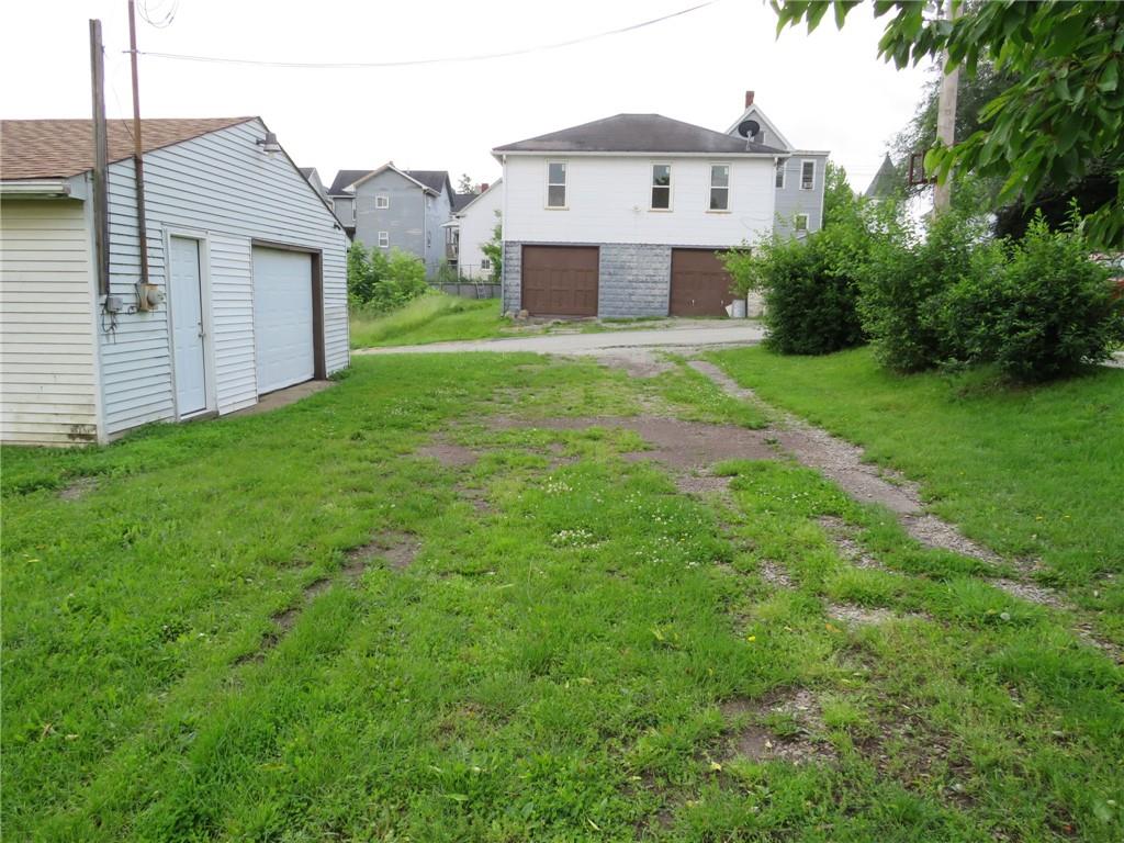 666 Ewing Street Washington, PA 15301 - Photo 20 of 22 a view of a house with yard and a garden