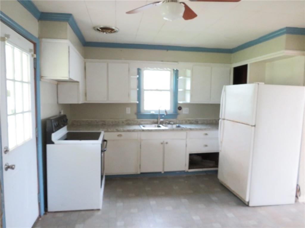 666 Ewing Street Washington, PA 15301 - Photo 4 of 22 a kitchen with a refrigerator sink stove and cabinets