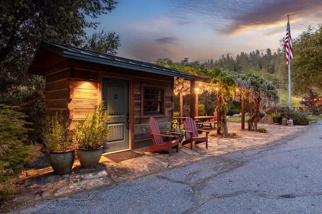a view of a patio with a table and chairs under an umbrella