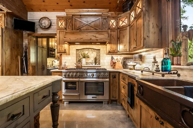 a kitchen with stainless steel appliances granite countertop a stove and a sink