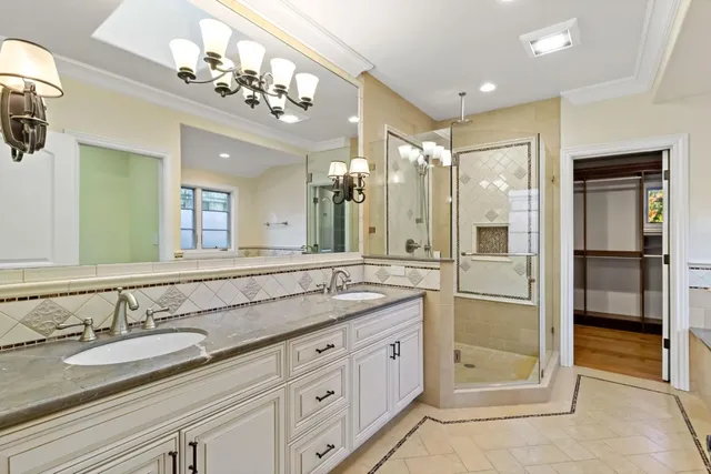 a spacious bathroom with a granite countertop sink mirror and shower