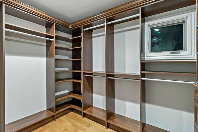 a view of walk in closet with empty racks