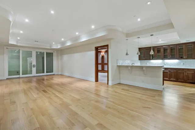 a spacious bathroom with a granite countertop double vanity sink and a mirror