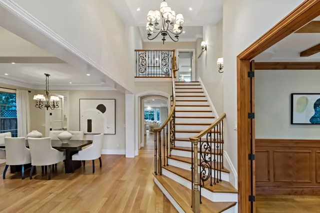 a view of a dining room with furniture a chandelier and wooden floor