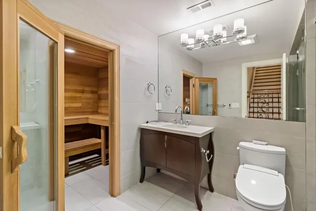 a view of a patio with table and chairs potted plants and a large tree